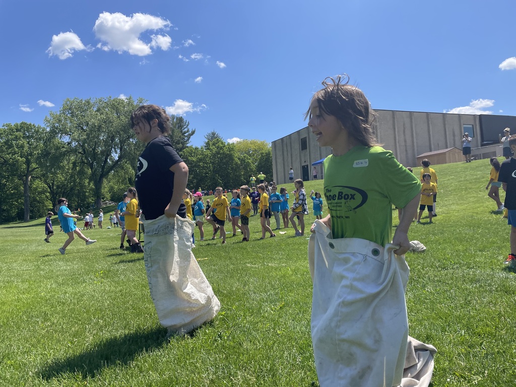 students in a potato sack race on field day
