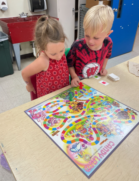 2 young children playing board game Candy Land