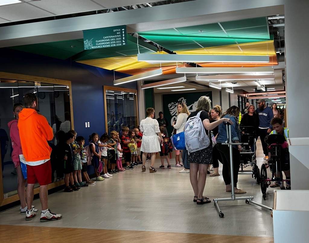 Students and staff in elementary hallway on first day of school
